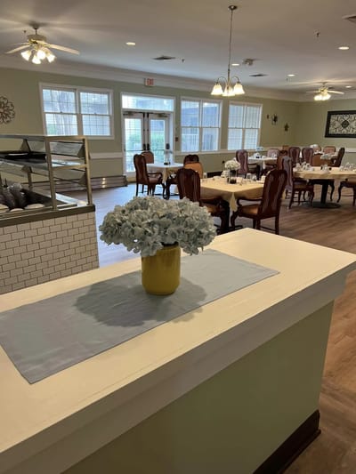 Dining area featuring tables and floral centerpiece