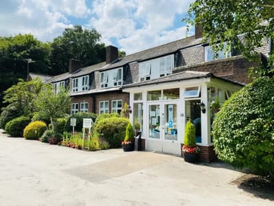 Exterior view of Cedar Court Care Home with landscaped gardens