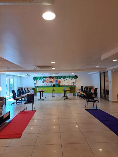 Bright common area with chairs and tables arranged