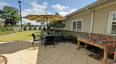 Outdoor seating area with an umbrella and plants