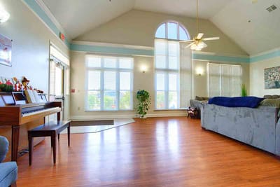 Bright common area with piano and seating