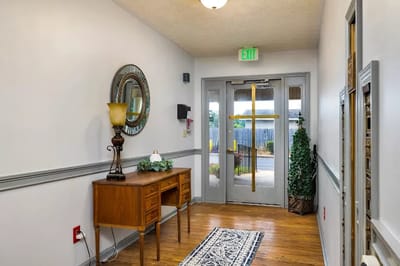 Bright interior hallway with wooden flooring and decor