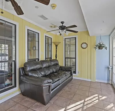Bright common area with a couch and large windows