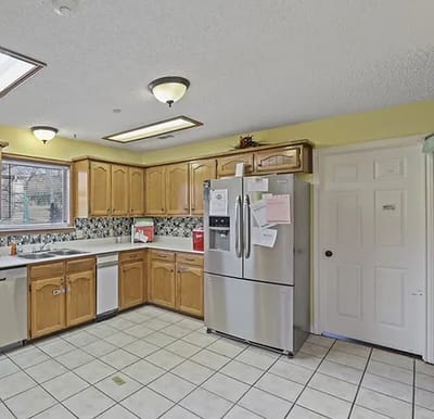 Bright kitchen area with wooden cabinets and appliances