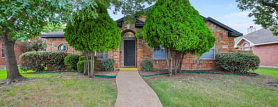 Exterior view of a senior living facility with landscaping