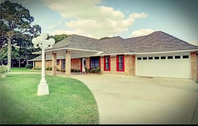 Exterior view of a senior living facility with landscaped garden