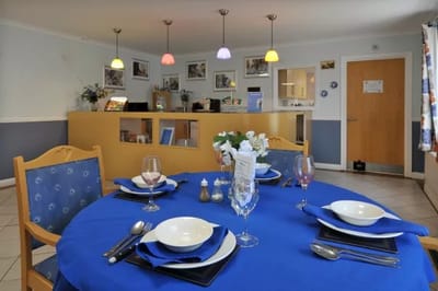 Dining area set for a meal with colorful decor