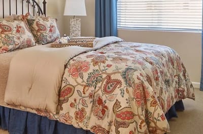 Cozy resident bedroom featuring decorative bedding