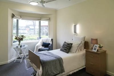 Cozy resident room with a bed and sitting area