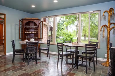 Interior common area with dining tables and large windows