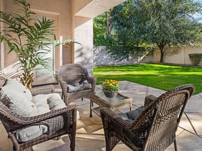 A cozy outdoor seating area with plants and lawn