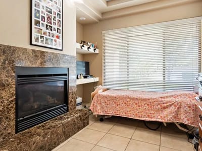 Cozy interior room with a fireplace and bed