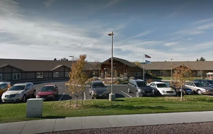 Exterior view of a senior living facility with parking lot