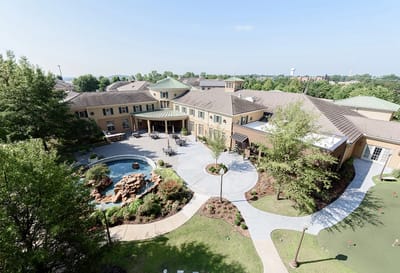 Aerial view of a senior living facility with gardens