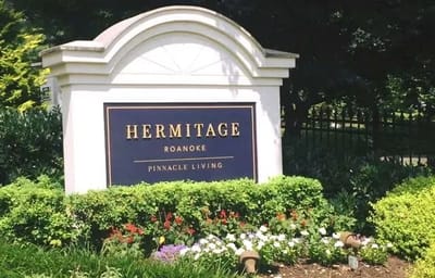 Sign for Hermitage Roanoke with floral landscaping