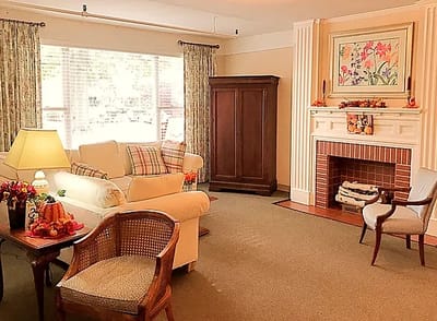 Cozy lounge area with seating and a fireplace