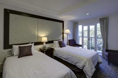 A well-furnished twin room in a senior living facility