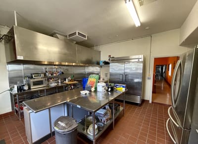 A commercial kitchen with stainless steel equipment