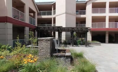 Outdoor courtyard with fountain and landscaping