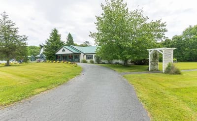 Pathway leading to the facility entrance surrounded by greenery