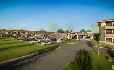 Exterior view of The Knolls facility with landscaping