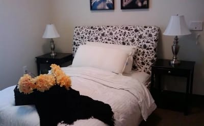 Cozy bedroom setup with flowers and decor