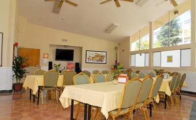 Bright dining area with tables and chairs set up
