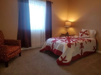 Cozy furnished bedroom with a vibrant quilt