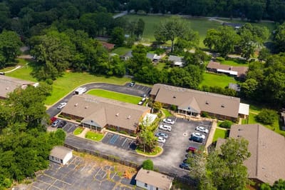 Aerial view of a senior living facility with parking and outdoor space