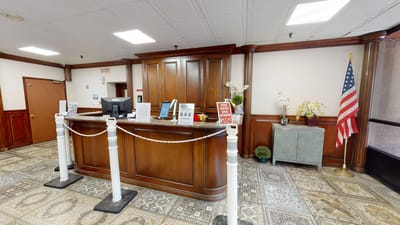 Reception area with wooden counter and American flag