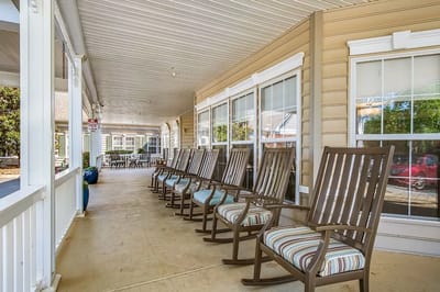 Covered porch with rocking chairs for residents.