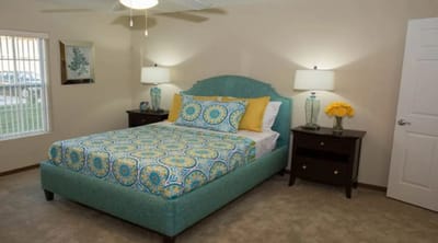 Cozy private resident room with a bed and lamps
