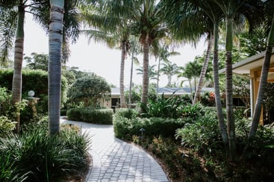 Pathway through a lush garden at an assisted living facility