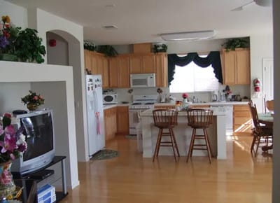 Bright kitchen area with wooden cabinets and dining space
