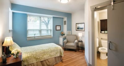 Cozy private room with a bed and seating area
