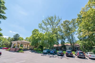 Exterior view of facility entrance surrounded by trees