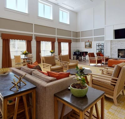 Bright common area with seating and piano