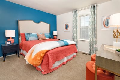 Cozy and colorful resident bedroom with a large bed