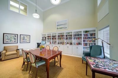 Interior of a common area with bookshelves and a table