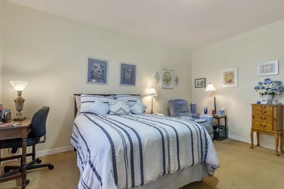 Cozy resident bedroom with desk and artwork