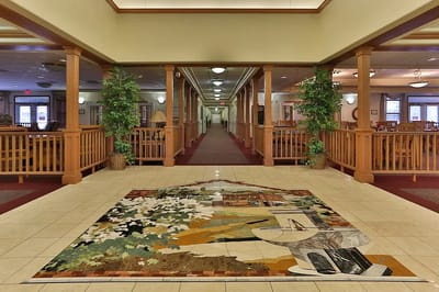 Interior view of a nursing home lobby with mural