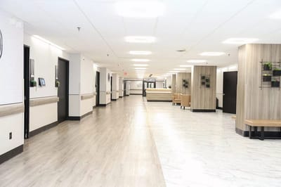 Bright interior hallway of a nursing home with seating areas