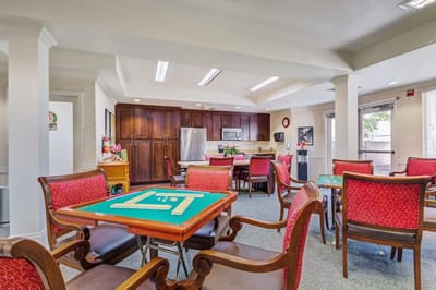Bright common area with card tables and seating