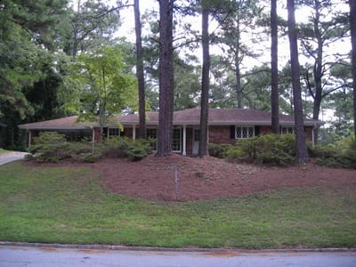 Exterior view of a senior living facility surrounded by trees