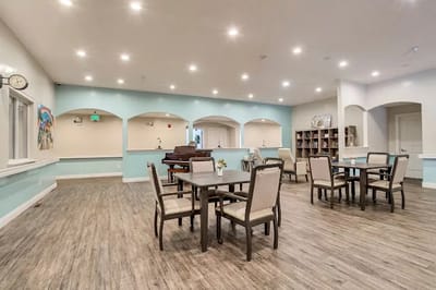 Bright activity room with tables and chairs