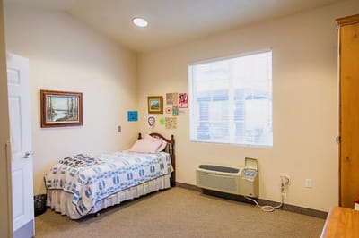 Cozy interior of a private resident room with bed and decor