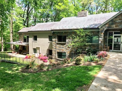 Exterior view of Althea Woodland Nursing Home surrounded by greenery