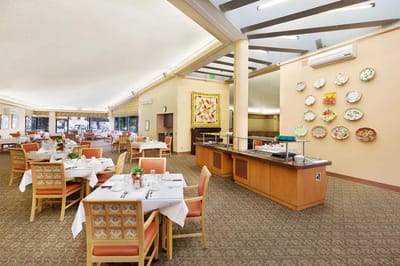 Dining room with tables set for residents