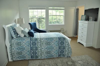 Bright private bedroom with white and blue decor
