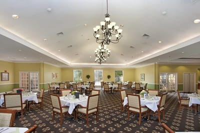 Bright dining room with tables set for meals